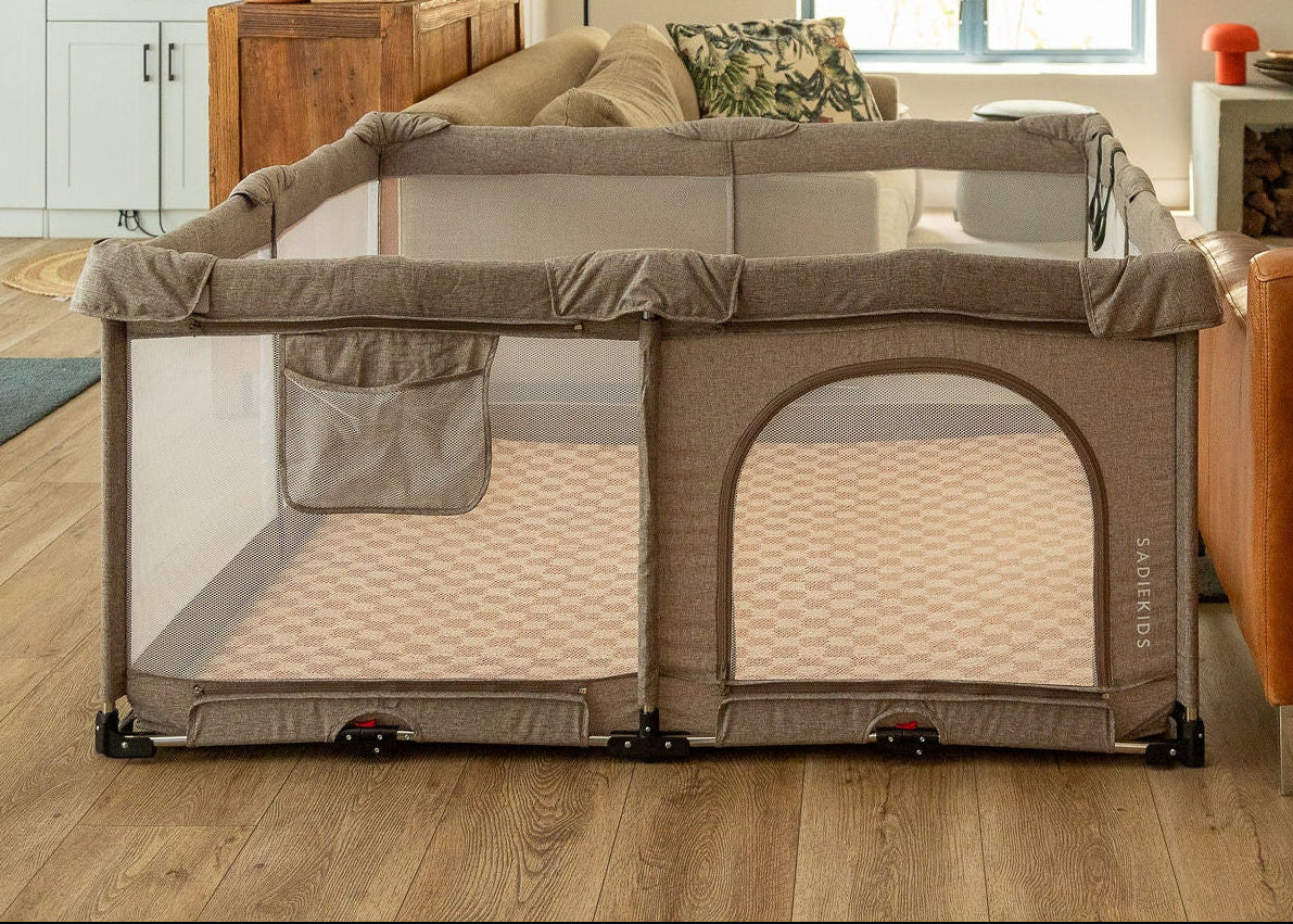 Portable playpen in a living room setting with furniture and decor.